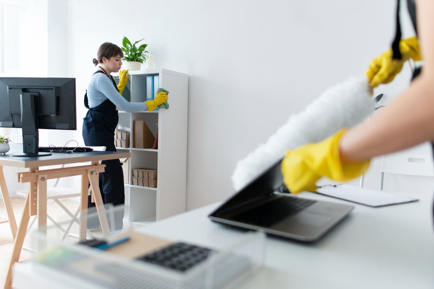 S/B Cleaning Expertise staff dusting and sanitizing office workspace in Austin