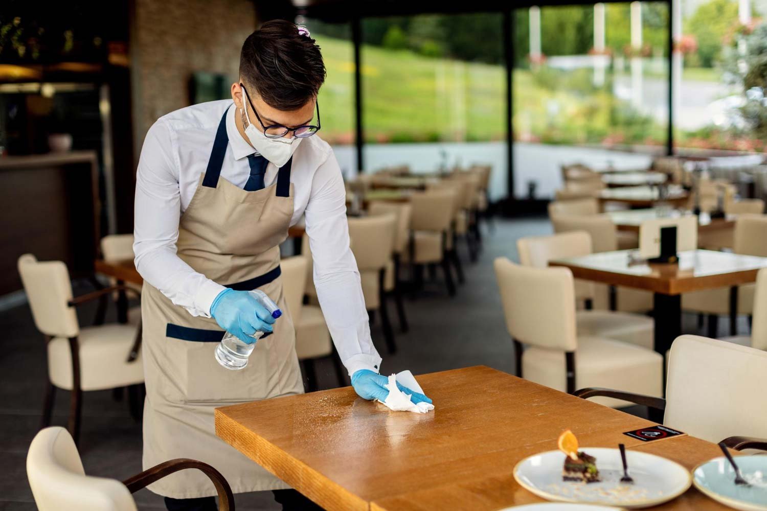Cleaner wiping down restaurant table at S/B Cleaning Expertise in Austin TX